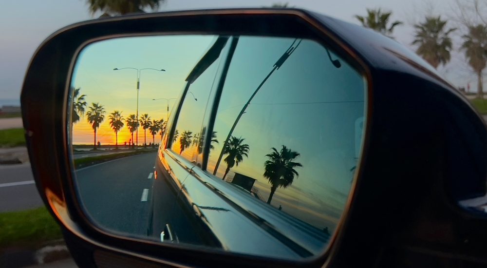 Rearview mirror of rental car in Maui