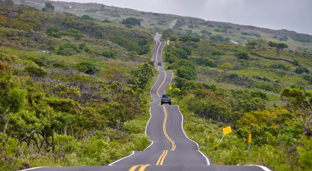 Cars driving up the road in Hawaii